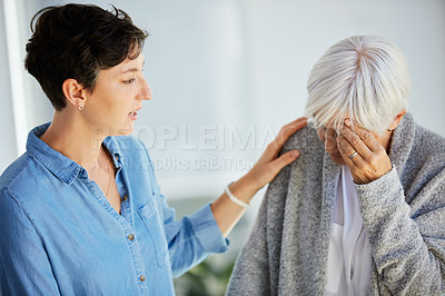 Buy stock photo Cropped shot of an affectionate young woman consoling her upset aged mother at home