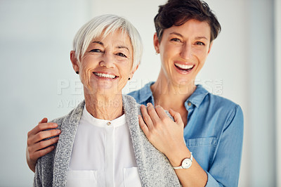 Buy stock photo Cropped portrait of an affectionate young woman embracing her aged mother at home