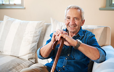 Buy stock photo Portrait of a senior man sitting at home with a walking stick