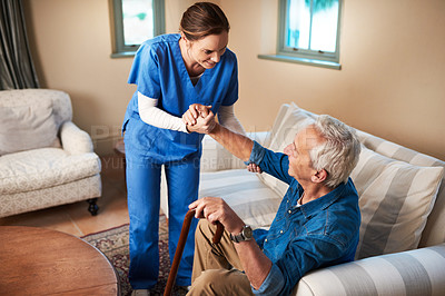Buy stock photo Shot of a caregiver assisting her senior patient at home