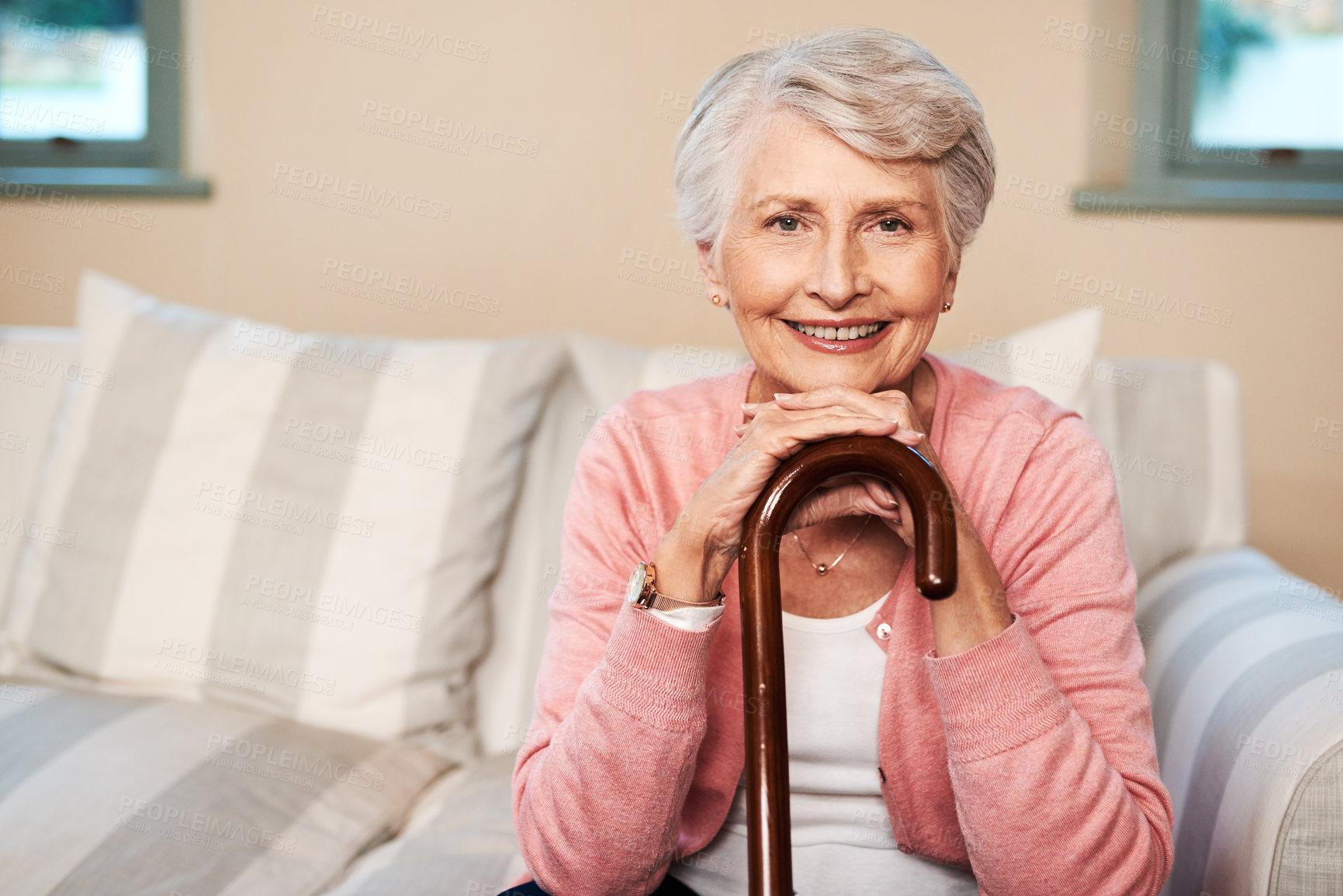 Buy stock photo Portrait of a senior woman sitting at home with a walking stick