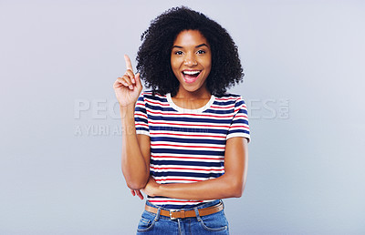 Buy stock photo Studio shot of an attractive young woman looking thoughtful against a grey background