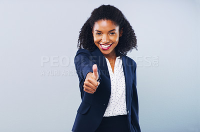 Buy stock photo Studio shot of an attractive young businesswoman giving thumbs up against a grey background
