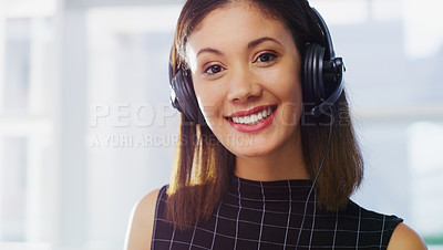 Buy stock photo Cropped portrait of an attractive young businesswoman wearing a headset while in the office during the day