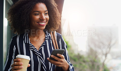 Buy stock photo Cropped shot of an attractive young businesswoman holding a coffee mug and using her cellphone while outside during the day