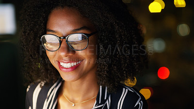 Buy stock photo Cropped shot of a young attractive businesswoman wearing glasses and working while in the office late at night