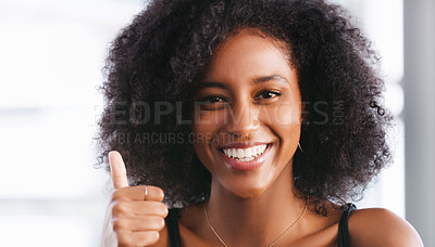 Buy stock photo Portrait of a confident young woman showing a thumbs up gesture