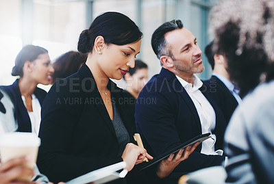 Buy stock photo Shot of a young businesswoman using a digital tablet while attending a conference