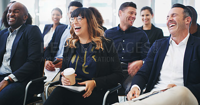 Buy stock photo Shot of a group of businesspeople laughing while attending a conference