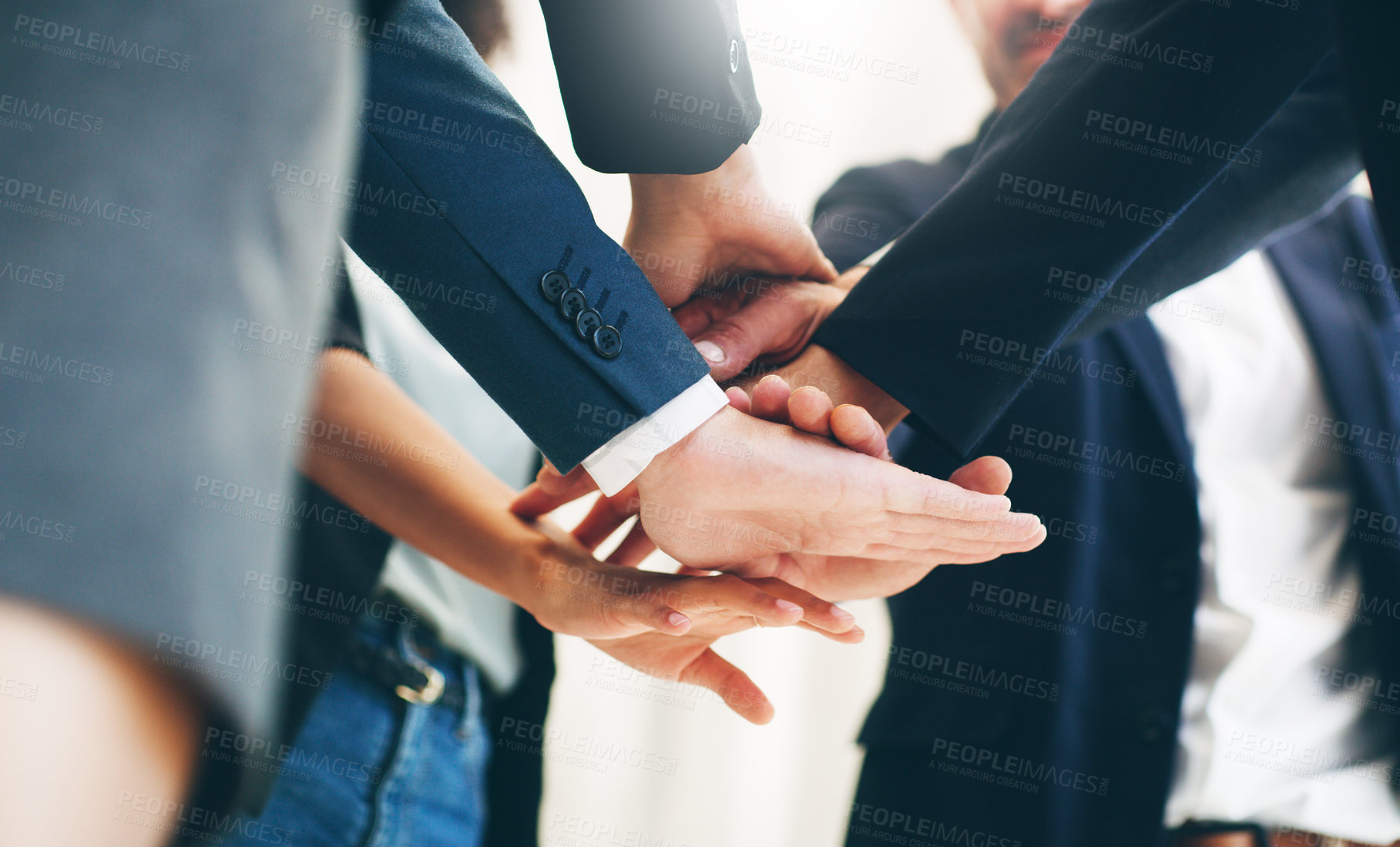 Buy stock photo Cropped shot of a group of businesspeople joining their hands in solidarity