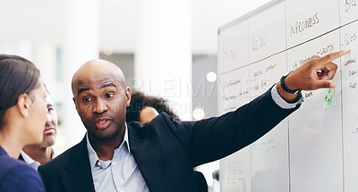 Buy stock photo Shot of a group of businesspeople having a brainstorming session in a modern office
