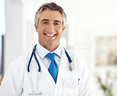 Buy stock photo Cropped portrait of a handsome mature male doctor standing in the hospital