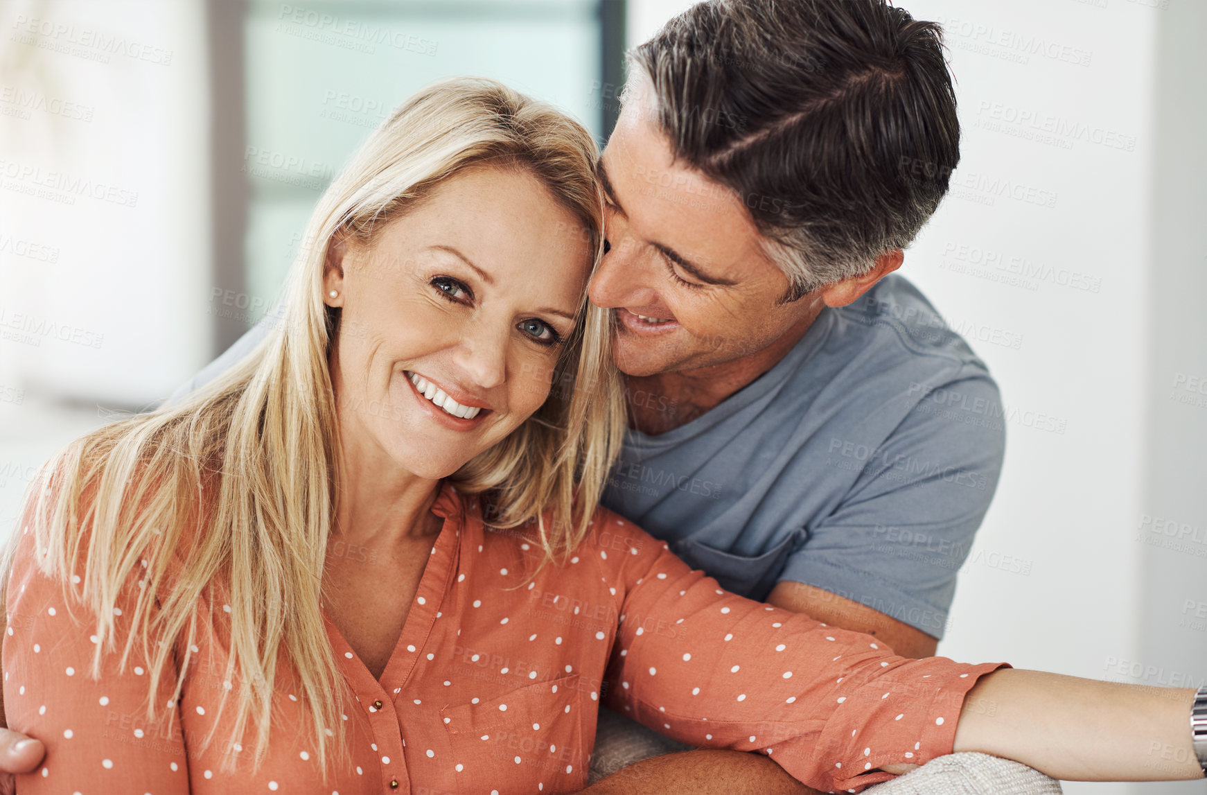 Buy stock photo Mature, couple and hug on sofa at house with love, marriage commitment and healthy relationship. Smile, woman and man with embrace for support, gratitude and bonding together of loyalty in morning