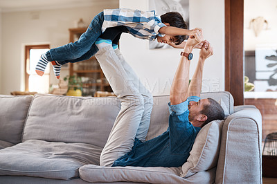 Buy stock photo Shot of a man spending quality time with his young son at home