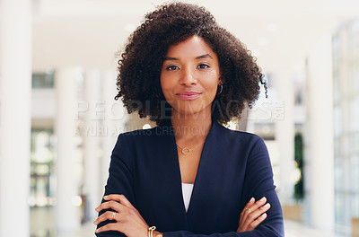 Buy stock photo Cropped portrait of an attractive young businesswoman standing with her arms crossed while in the office during the day