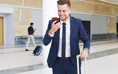 Buy stock photo Cropped shot of a handsome young businessman using his cellphone and showing excitement while in the office during the day