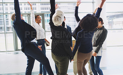 Buy stock photo Cropped shot of a diverse group of businesspeople celebrating and throwing their hands up while in the office