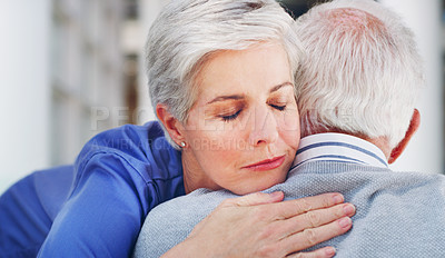 Buy stock photo Cropped shot of an attractive mature healthcare professional hugging her senior patient while indoors during the day