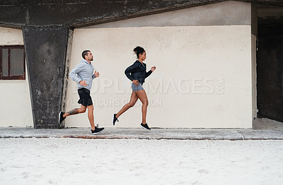 Buy stock photo Full lengths shot of a sporty young couple running together outdoors