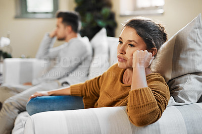 Buy stock photo Shot of a young woman ignoring her boyfriend after having an argument
