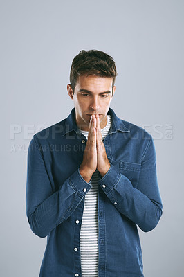Buy stock photo Cropped shot of a handsome man looking anxious against a grey background