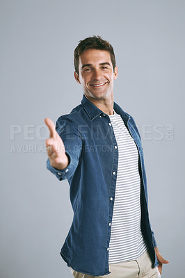 Buy stock photo Cropped shot of a handsome man reaching for a handshake