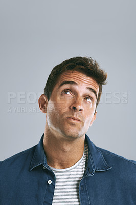 Buy stock photo Cropped shot of a man looking up against a grey background