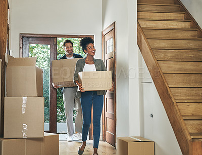 Buy stock photo Interracial couple moving into a new modern house, carrying boxes and arriving home together. Happy, excited and smiling husband and wife walking, entering and relocating after buying an apartment