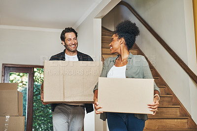Buy stock photo Couple homeowners moving in, carrying boxes and unpacking in new purchased home as real estate investors. Smiling, happy and cheerful interracial man and woman, first time buyers and property owners