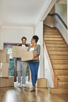 Buy stock photo Full length shot of an affectionate young couple smiling while carrying boxes into their new home