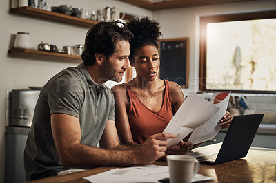 Buy stock photo Cropped shot of an affectionate young couple going through paperwork while doing their budget at home
