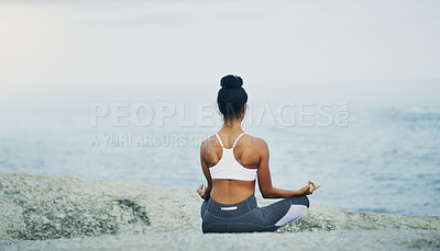 Buy stock photo Lotus, yoga or girl in beach meditation for peace, wellness or mindfulness in outdoor nature to relax. Chakra, calm or back view of woman on rock at sea or ocean for awareness or balance in pilates
