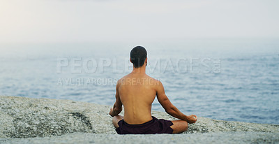 Buy stock photo Lotus, yoga or man in beach meditation for peace, wellness or mindfulness in outdoor nature. Chakra, calm or back view of yogi on rock at sea or ocean for awareness or balance in pilates to relax 
