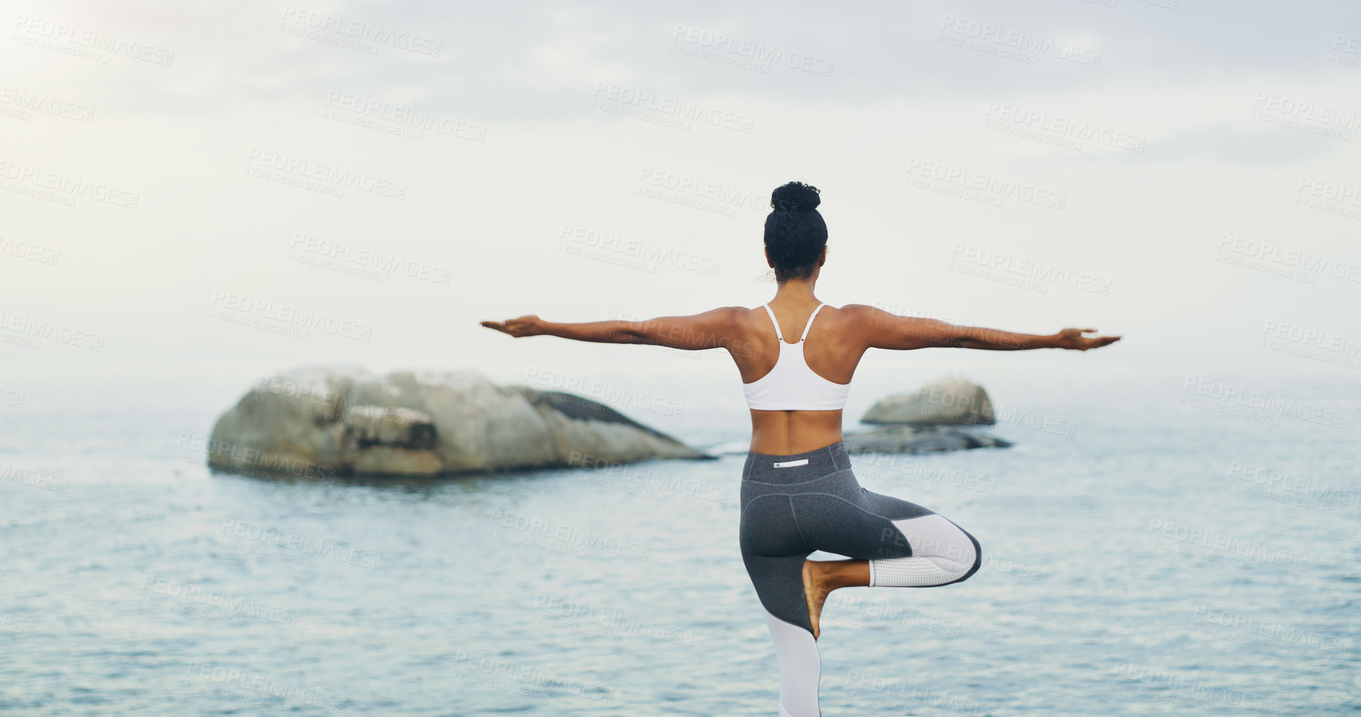 Buy stock photo Beach, yoga or woman with balance or body flexibility for peace or mindfulness in outdoor nature to relax. Chakra, calm or back view of girl on rock at sea or ocean for awareness or soul in pilates