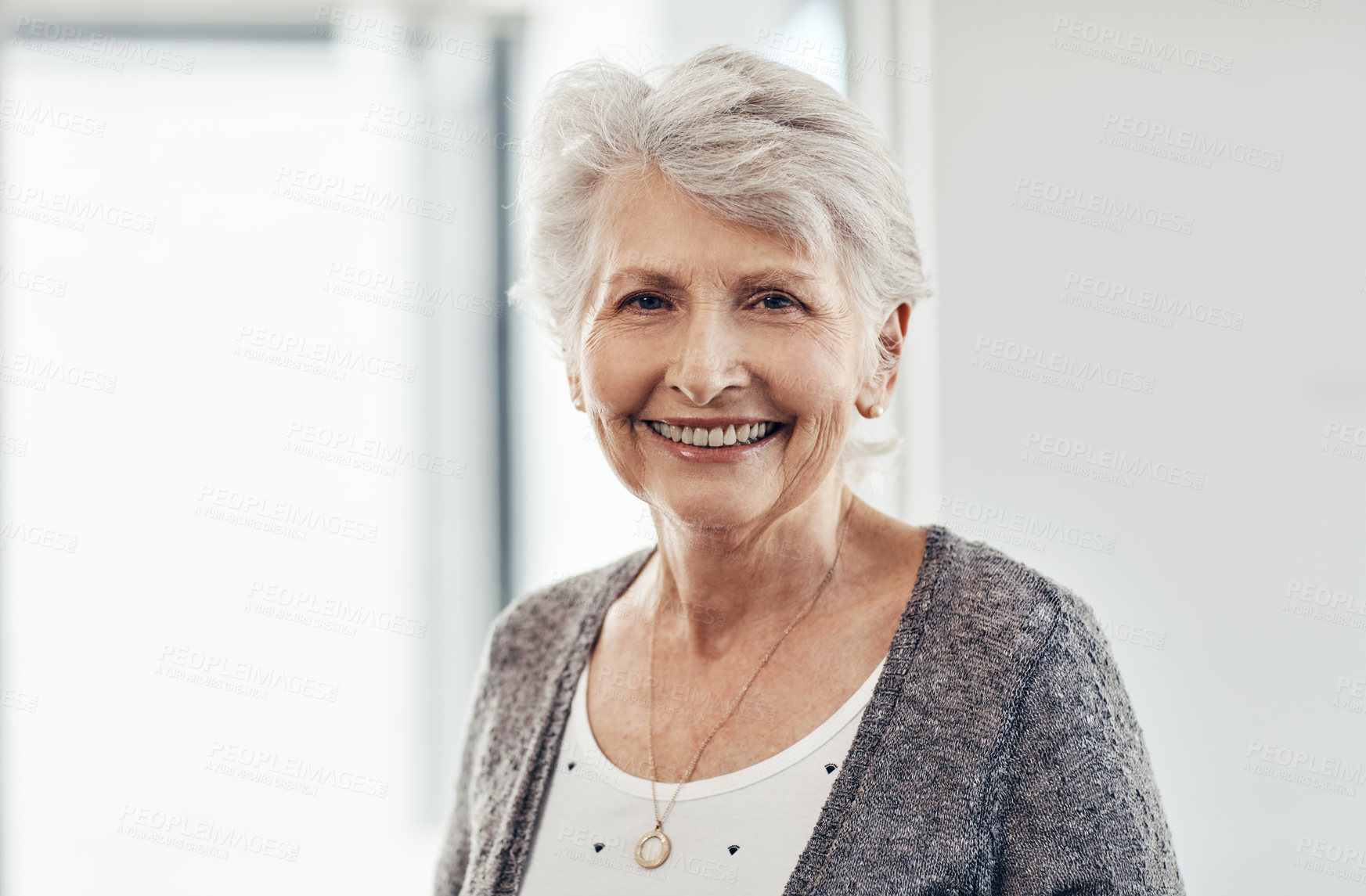 Buy stock photo Cropped shot of a senior woman smiling at the camera