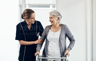 Buy stock photo Shot of a female nurse assisting a senior woman using a walker