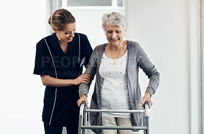 Buy stock photo Shot of a female nurse assisting a senior woman using a walker