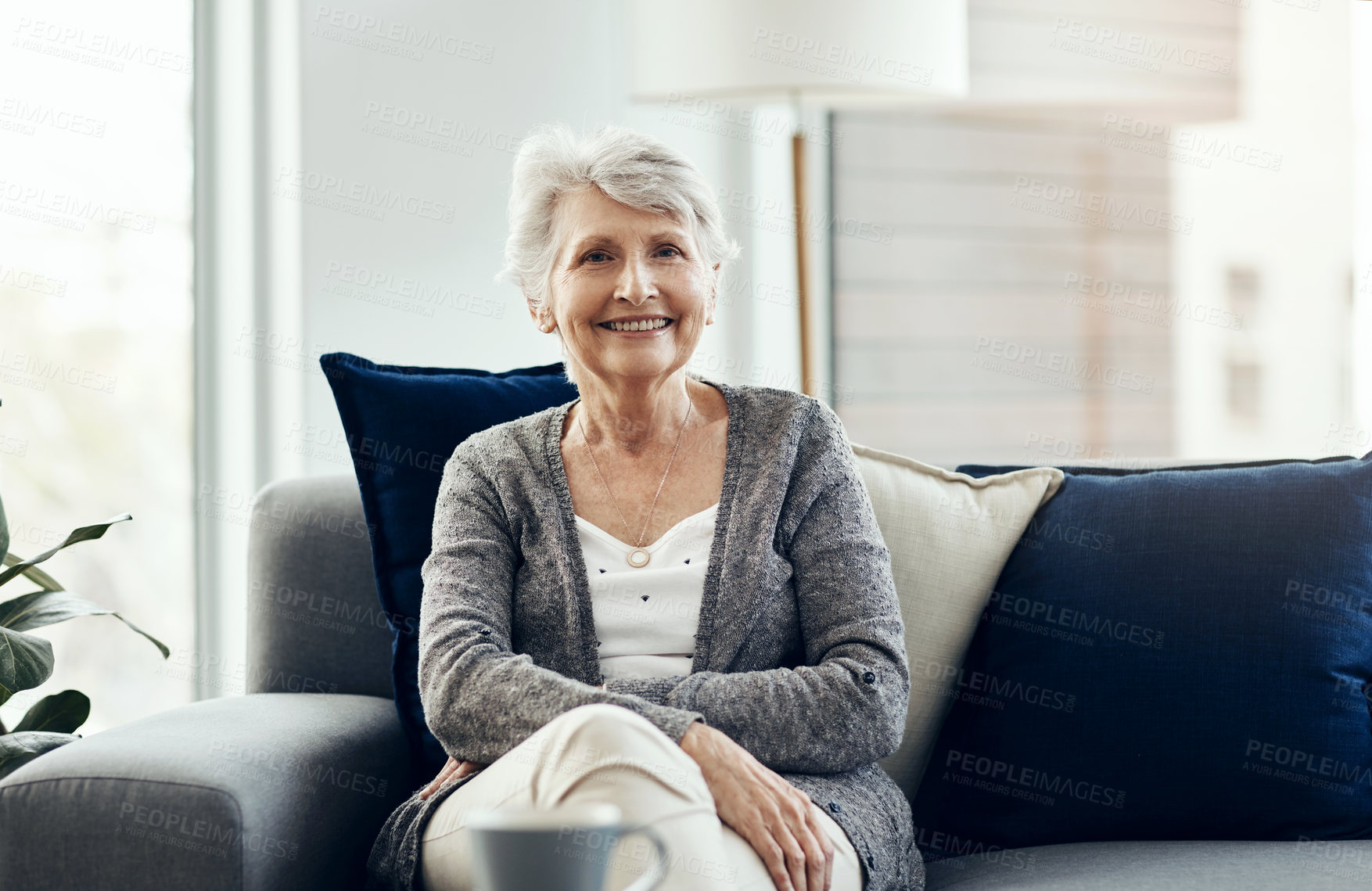 Buy stock photo Shot of a senior woman relaxing on the sofa at home