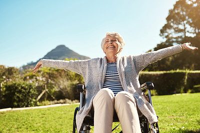 Buy stock photo Shot of a senior woman enjoying the outdoors while sitting in her wheelchair