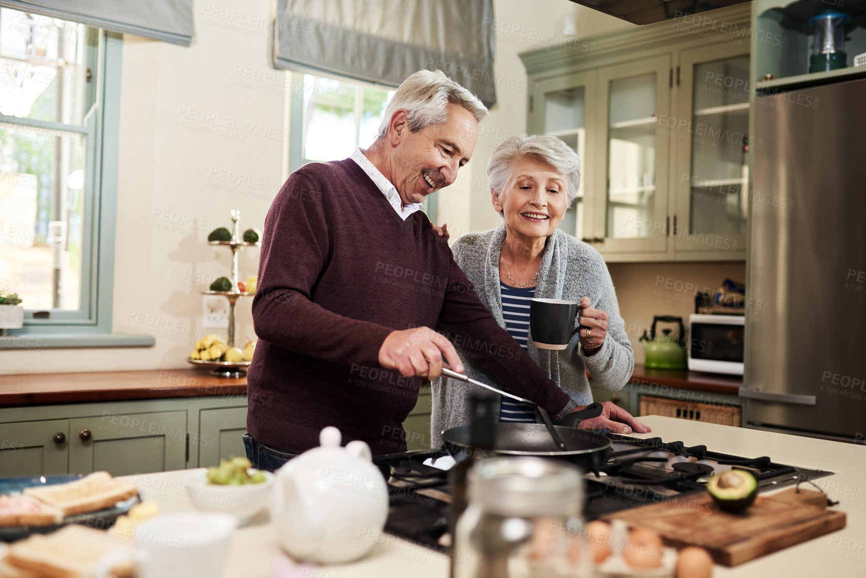 Buy stock photo Senior couple, kitchen and cooking together on stove, bonding and breakfast for food and coffee. Home, happy and married people in house for brunch in retirement, ingredients and support with love 