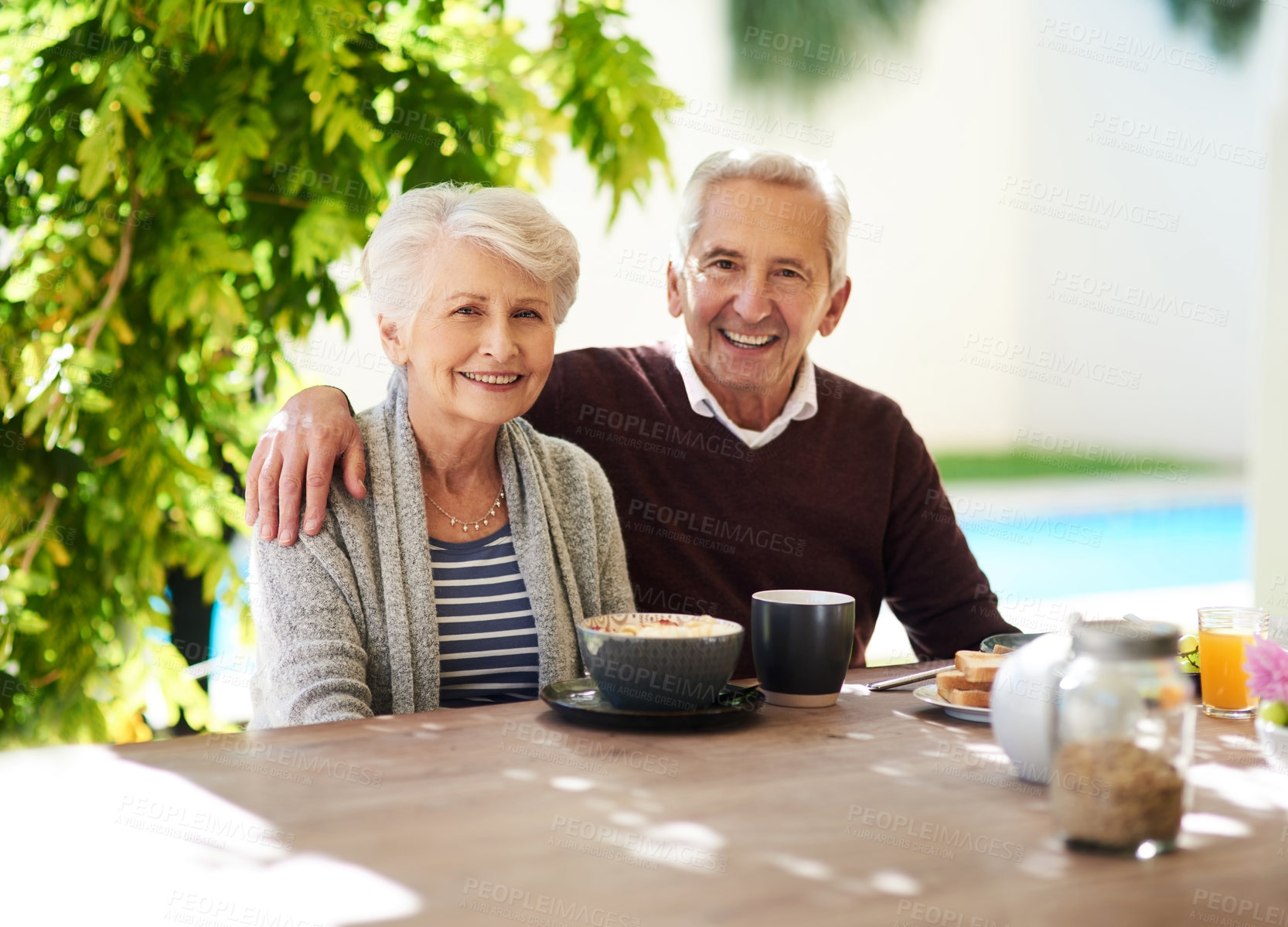 Buy stock photo Portrait of an affectionate senior couple enjoying a meal together outdoors