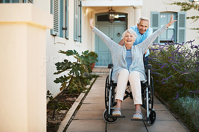 Buy stock photo Full length shot of a cheerful senior man pushing his wife in a wheelchair in their backyard at home