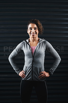 Buy stock photo Cropped portrait of an attractive young woman standing against a black background in her workout clothes before exercising