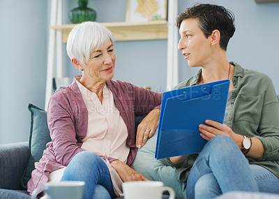 Buy stock photo Cropped shot of an attractive young healthcare professional sitting with her senior patient and discussing her medical results