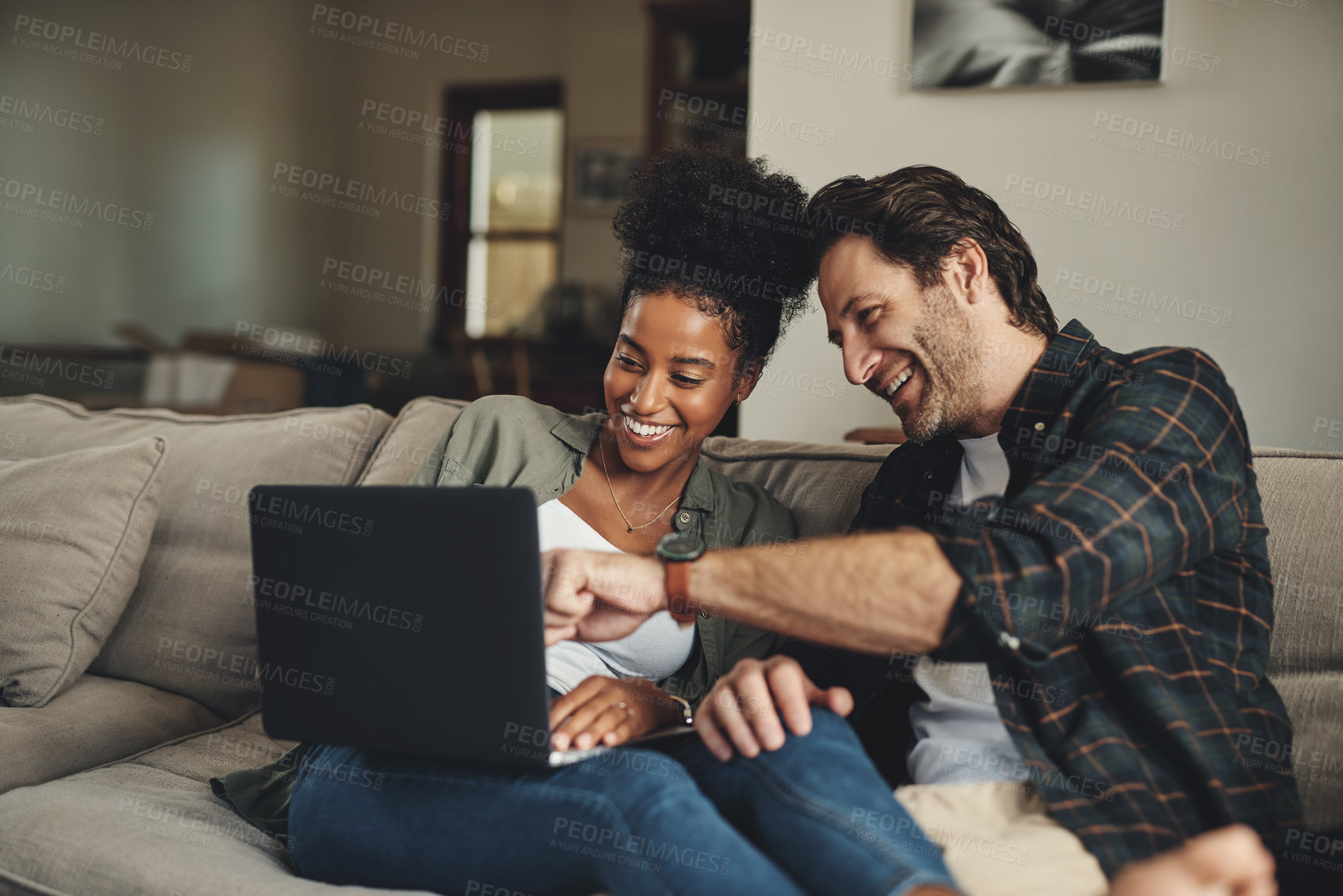 Buy stock photo Laptop, interracial and entertainment with a couple watching a video using an online subscription service to relax. Computer, streaming or internet with a man and woman bonding together over a movie