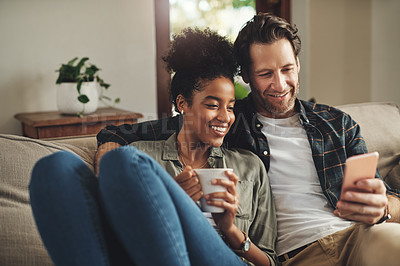 Buy stock photo Home, relax and interracial couple on a couch, smartphone and happiness with connection, mobile app and social media. Partners, happy man and woman with a cellphone, communication and online reading