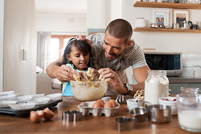 Buy stock photo Cropped shot of a young man baking at home with his young daughter
