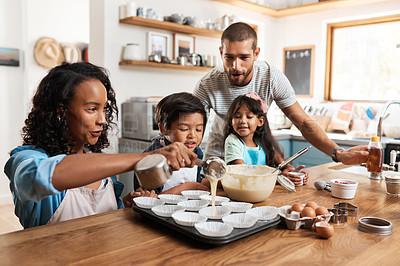 Buy stock photo Cropped shot of a young couple baking at home with their two children