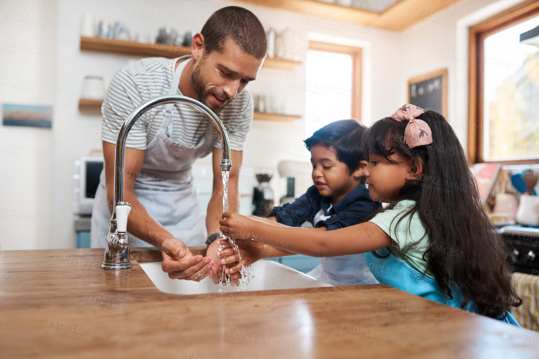 Buy stock photo Cropped shot of a man and his two children washing their hands in the kitchen basin