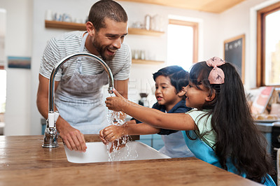 Buy stock photo Cropped shot of a man and his two children washing their hands in the kitchen basin